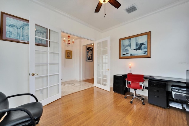 home office with ceiling fan with notable chandelier, wood-type flooring, ornamental molding, and french doors