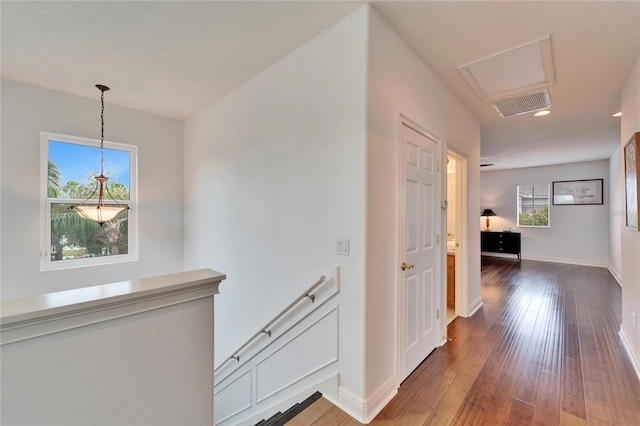 hallway with hardwood / wood-style floors