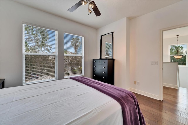 bedroom with hardwood / wood-style floors and ceiling fan