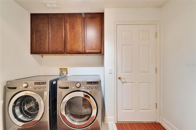 washroom with cabinets, light tile patterned floors, and independent washer and dryer