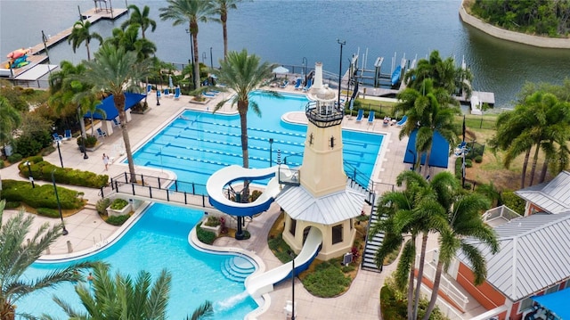 view of pool with a water view, a water slide, and a patio