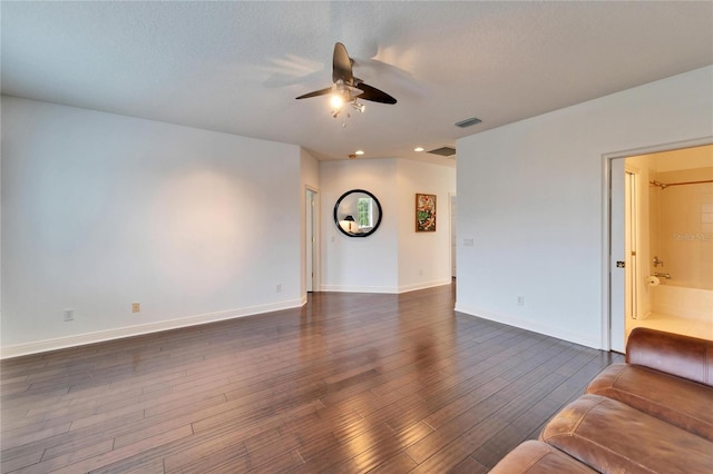 unfurnished living room featuring a textured ceiling, dark hardwood / wood-style floors, and ceiling fan