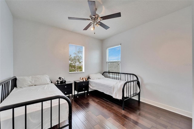 bedroom with dark wood-type flooring and ceiling fan