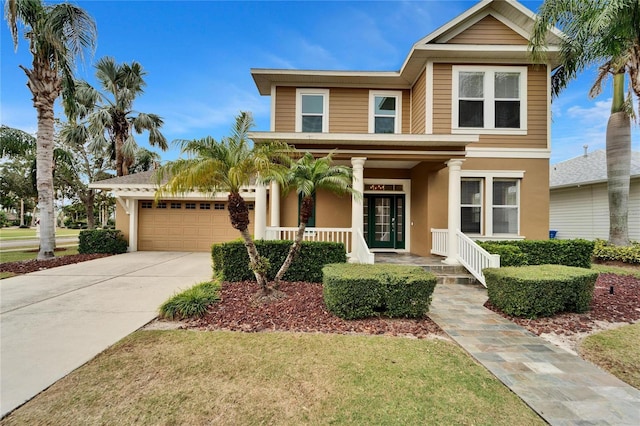 view of front of property featuring a porch, driveway, an attached garage, and stucco siding