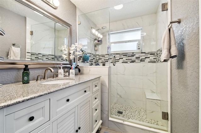 bathroom with vanity and a shower with shower door