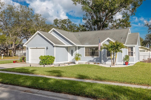 ranch-style home featuring a garage and a front lawn