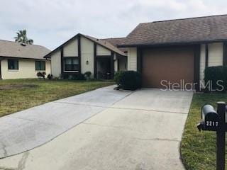 single story home with a garage and a front yard