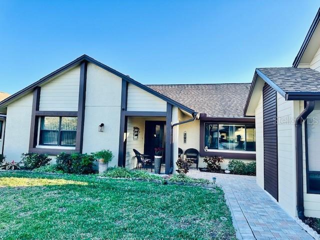 view of front of property featuring a patio area and a front lawn