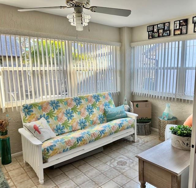 sunroom with ceiling fan and plenty of natural light