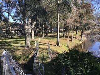 exterior space featuring a water view and a lawn