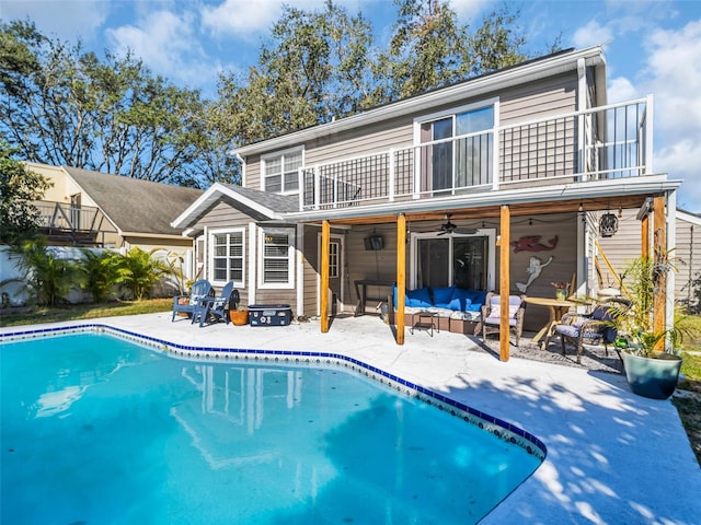 back of house featuring ceiling fan, a patio area, outdoor lounge area, and a balcony