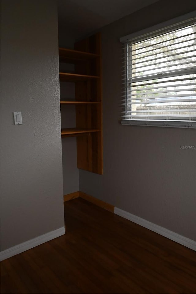 unfurnished room featuring dark hardwood / wood-style floors