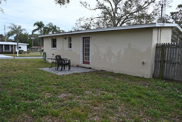 rear view of property with a yard