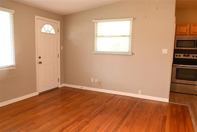 foyer entrance with lofted ceiling and wood-type flooring