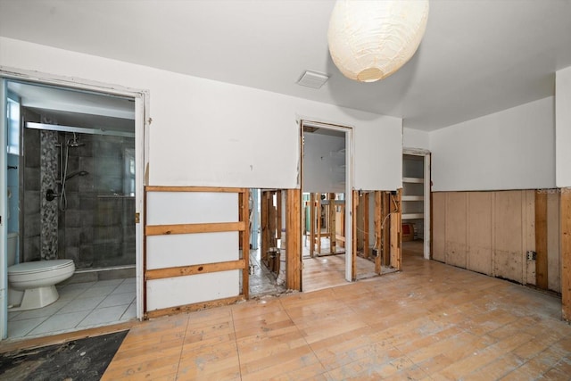 spare room featuring wooden walls