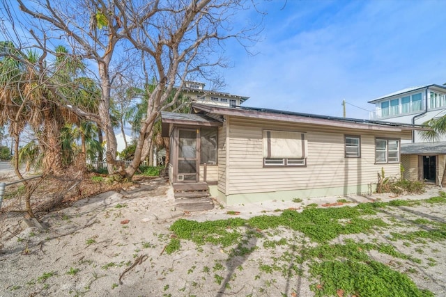 view of front of house with a sunroom