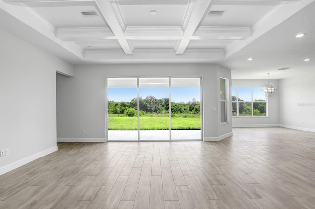 empty room with coffered ceiling, an inviting chandelier, light wood-type flooring, ornamental molding, and beam ceiling