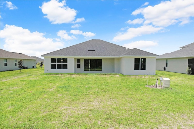 rear view of house with a lawn