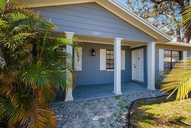 doorway to property featuring covered porch