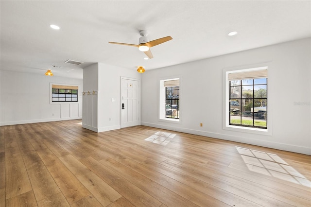 unfurnished living room with ceiling fan and light hardwood / wood-style flooring