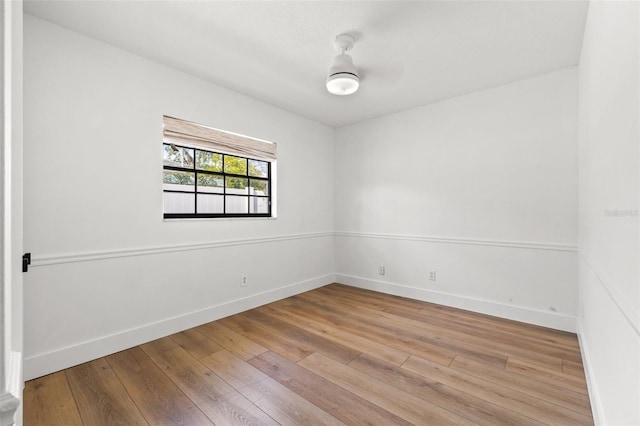 empty room with ceiling fan and light hardwood / wood-style floors