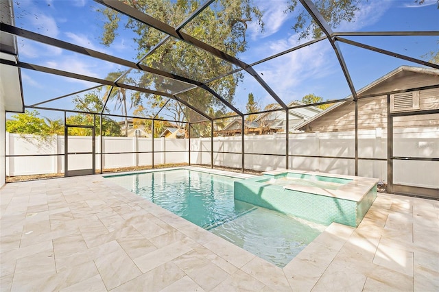 view of pool featuring an in ground hot tub, glass enclosure, and a patio area