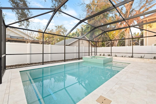 view of swimming pool with a patio area, a pool with connected hot tub, glass enclosure, and fence