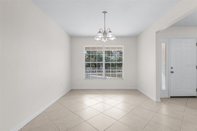 interior space featuring light tile patterned floors and an inviting chandelier