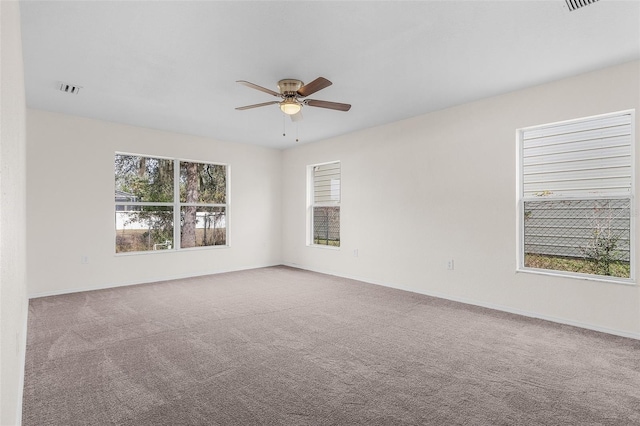 carpeted empty room featuring ceiling fan