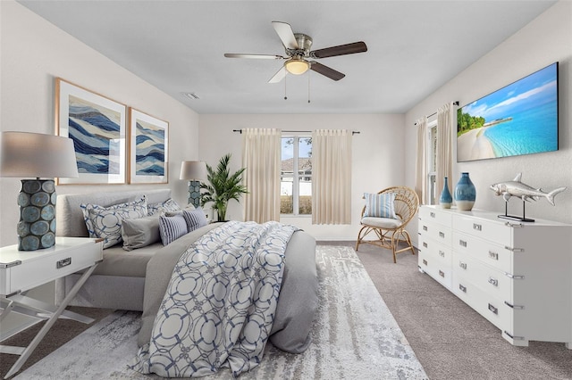 bedroom with ceiling fan and light colored carpet