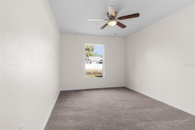 carpeted spare room with ceiling fan