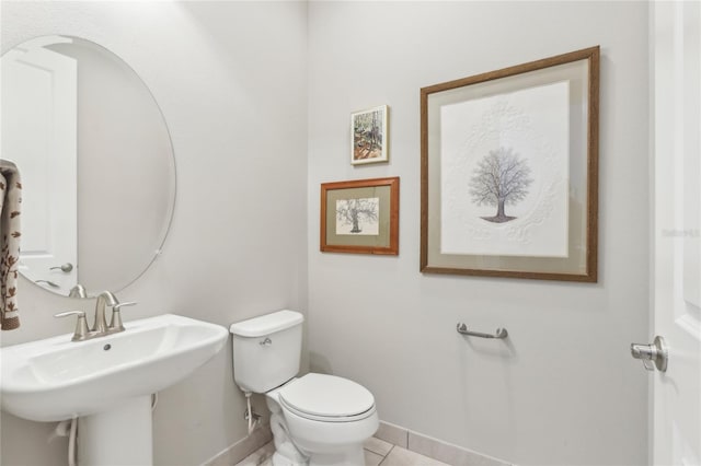 bathroom featuring tile patterned floors, toilet, and sink