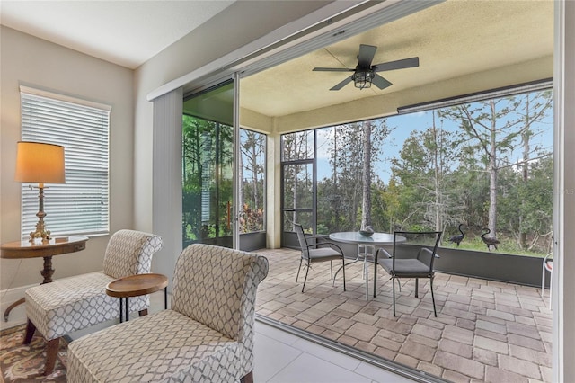 sunroom / solarium with a wealth of natural light and ceiling fan