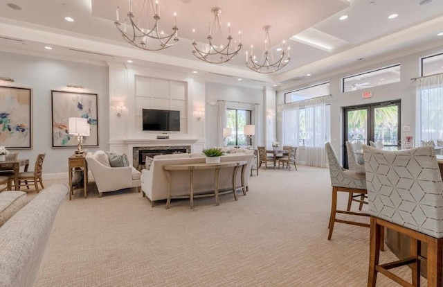 living room featuring french doors, an inviting chandelier, a tray ceiling, a wealth of natural light, and light colored carpet