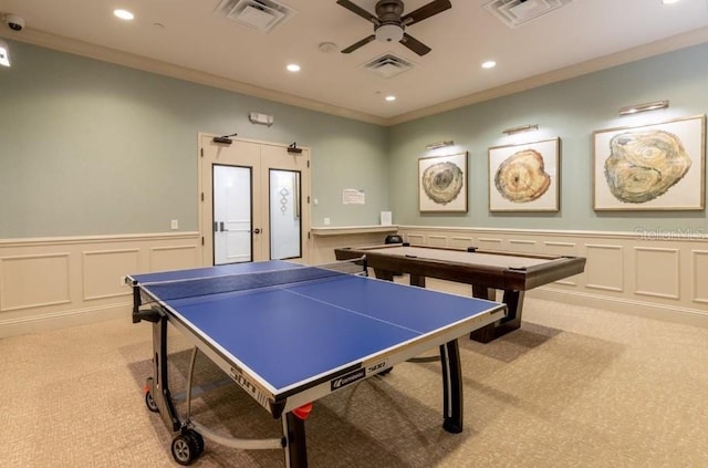 rec room featuring french doors, ceiling fan, ornamental molding, and light carpet