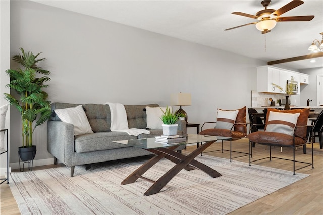 living room with ceiling fan and light hardwood / wood-style floors