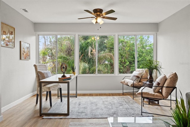 sunroom featuring ceiling fan