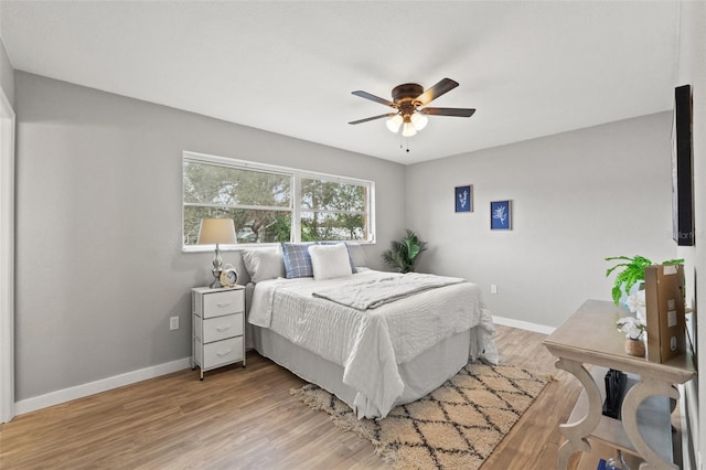 bedroom with ceiling fan and light hardwood / wood-style flooring