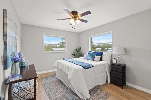 bedroom with ceiling fan and light hardwood / wood-style flooring