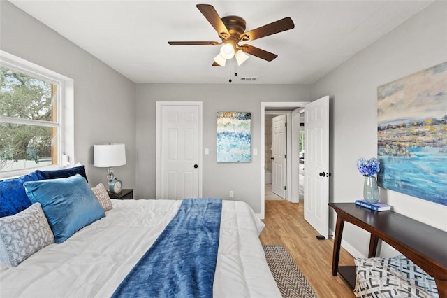 bedroom with ceiling fan and light wood-type flooring