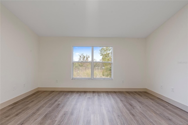 empty room with light hardwood / wood-style flooring