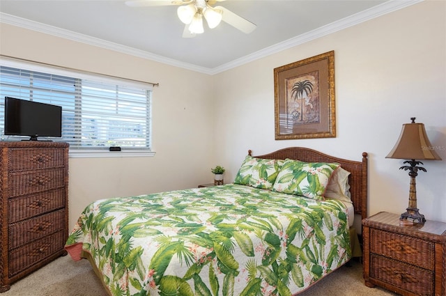 carpeted bedroom with ceiling fan and crown molding