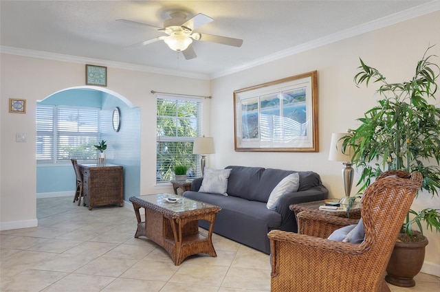 living room with ceiling fan, light tile patterned floors, ornamental molding, and a healthy amount of sunlight