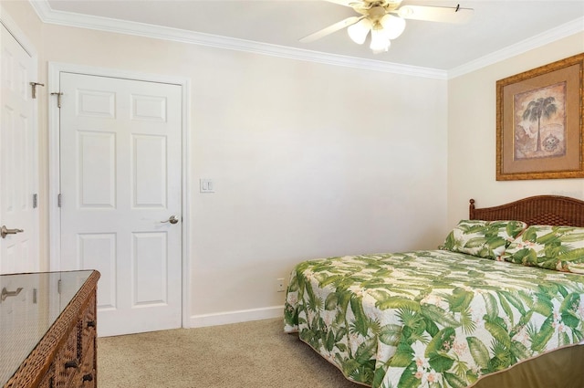 bedroom with ceiling fan, carpet, and crown molding