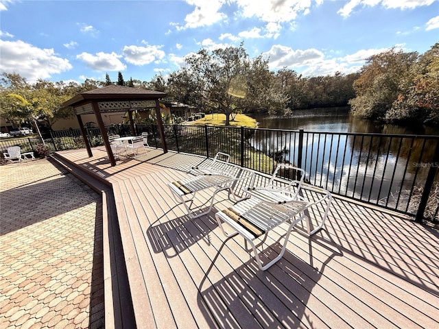 deck with a gazebo and a water view