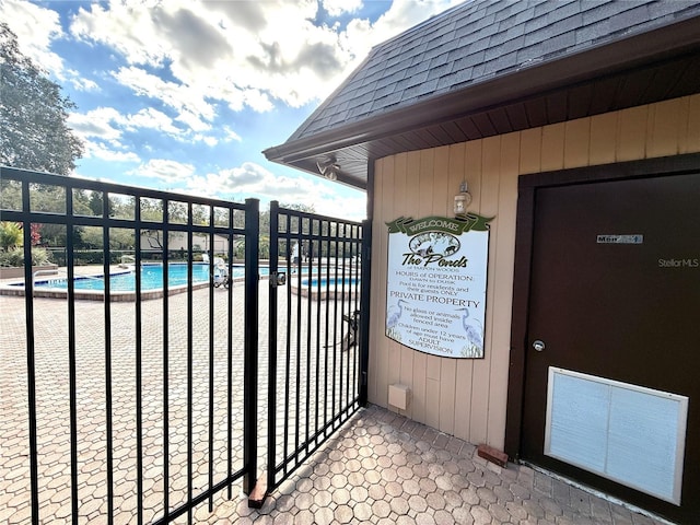 view of gate with a community pool