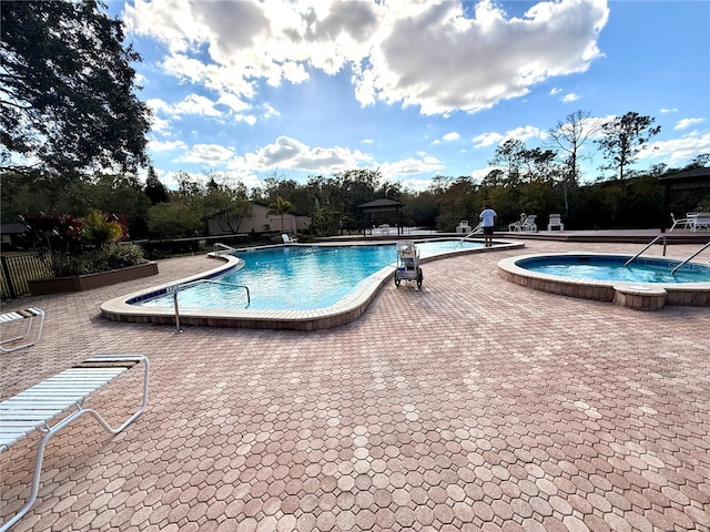 view of swimming pool with a patio, a gazebo, and a hot tub