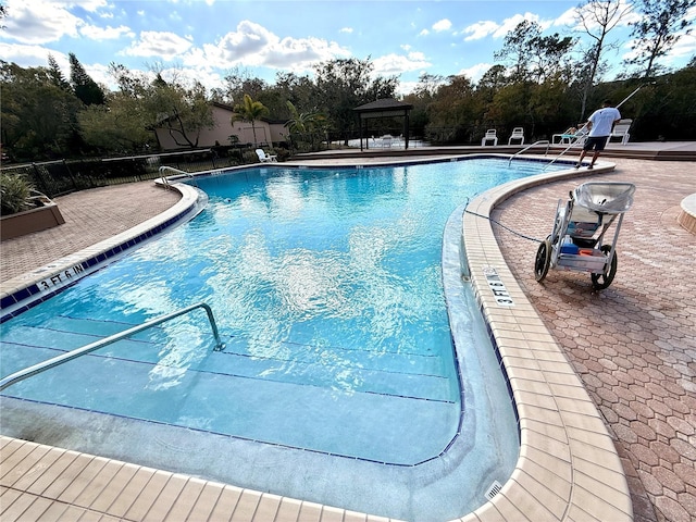 view of swimming pool with a patio and a gazebo