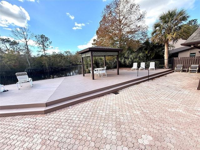 wooden deck with a gazebo and a water view