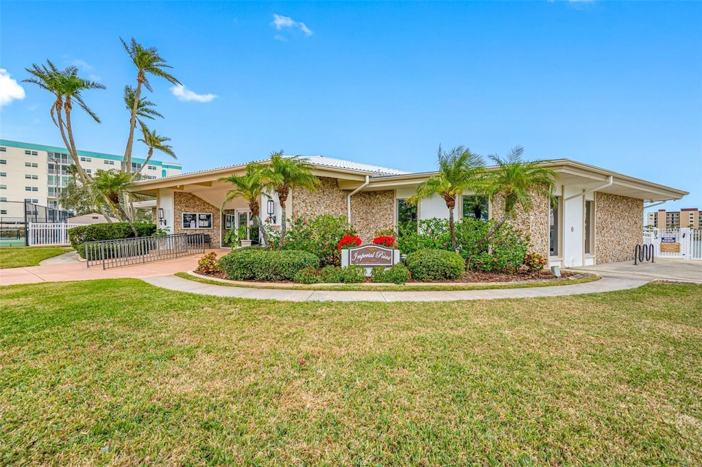 ranch-style home with a front lawn